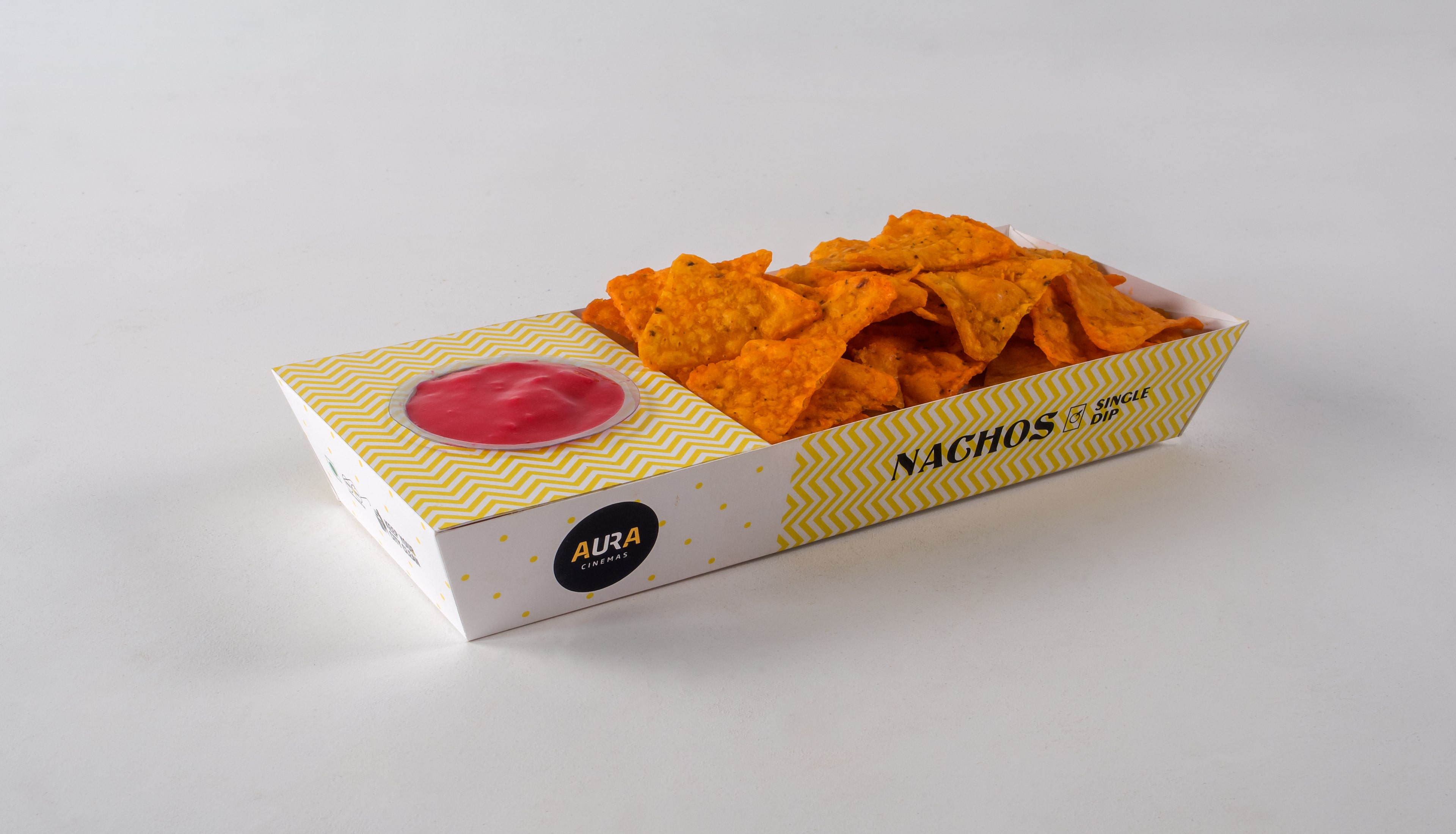 Aura Cinemas nachos with single dip in a stylish yellow zigzag-patterned tray, perfect for a tasty cinema snack
